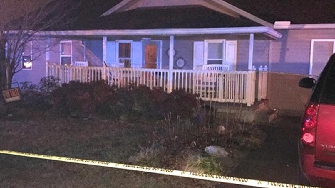 State police found three people dead inside this home in Whitley County, where a woman with a gun was shot by an officer Friday night.