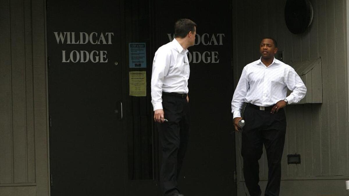 Leon Smith, right, then director of basketball operations, talked with another staffer outside Wildcat Lodge in March 2007 when media waited for word on coach Tubby Smith’s future.