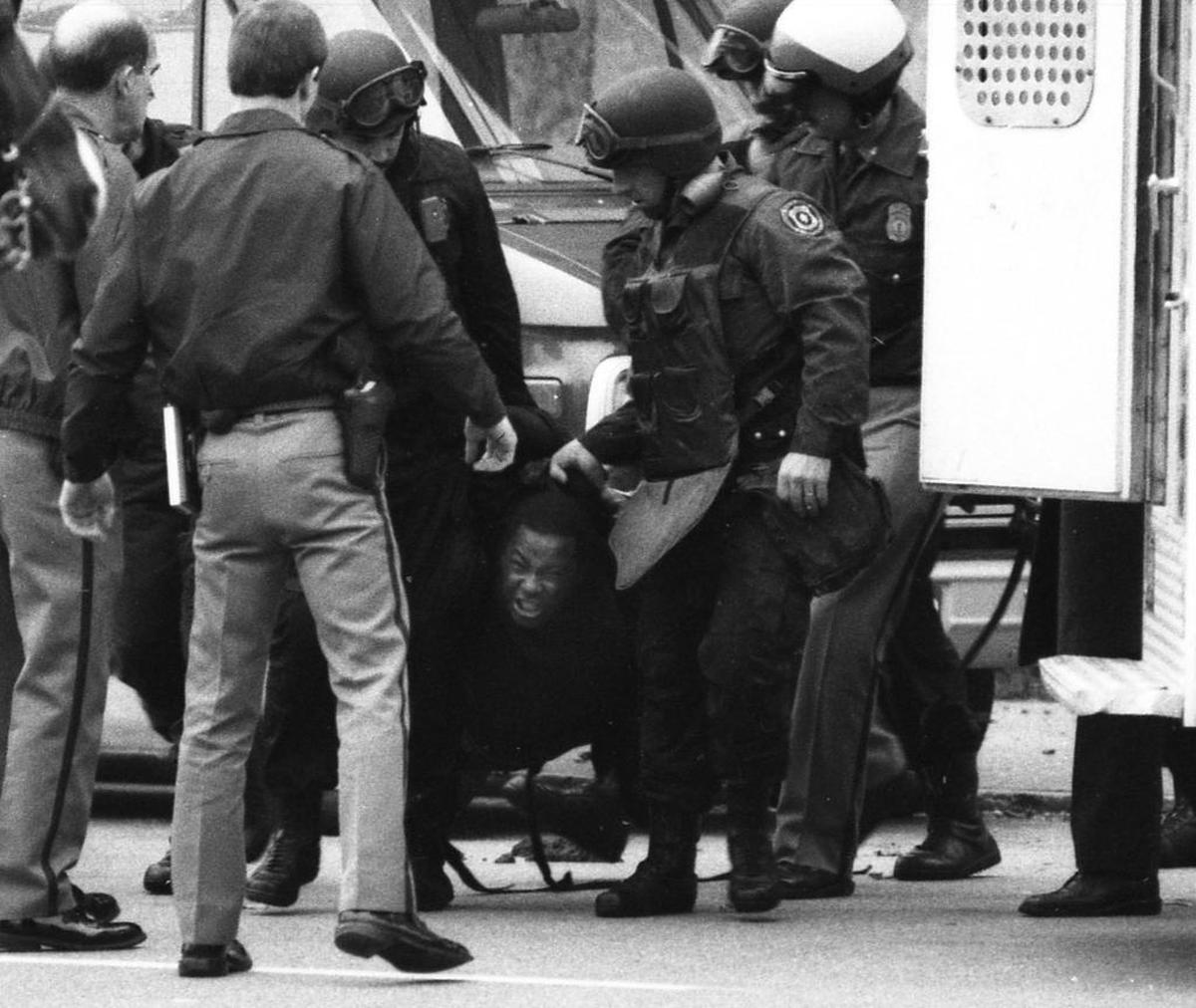 Lexington police carried Ulysses S. Davis III, kicking and screaming, from the University of Kentucky's Peterson Service Building December 10, 1986. Davis, a former UK custodian, dressed as a Ninja warrior, took over a campus building for 11 hours and sprayed the area with gunfire. Two people were wounded before police blasted a 40-inch Samurai sword from his hand with a fire hose and overpowered him.