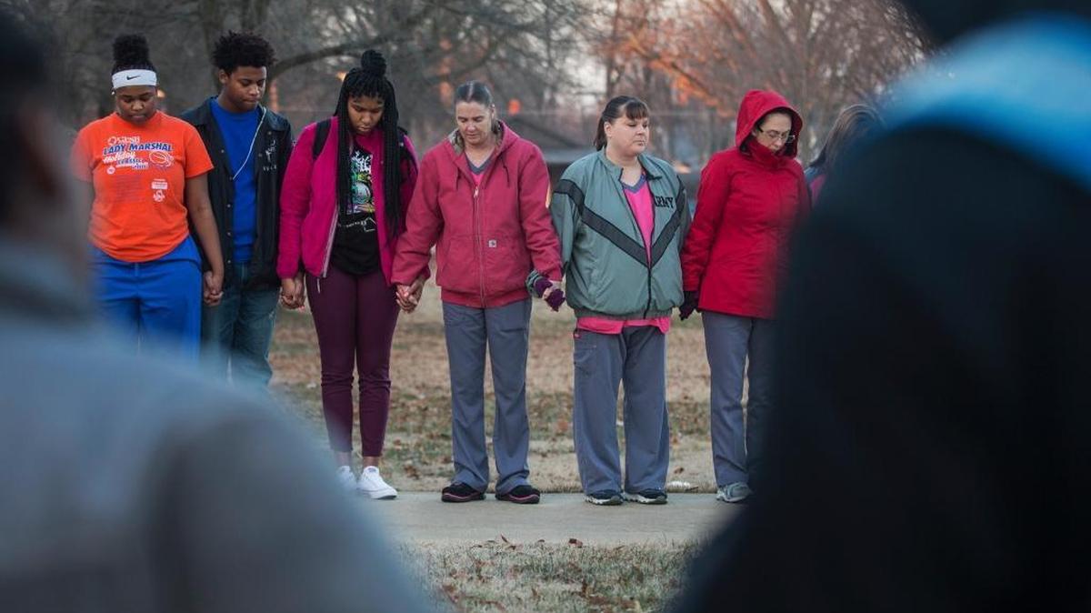 Students and community members held hands in prayer before classes at Paducah Tilghman High School in Paducah, Ky., Wednesday, Jan. 24, 2018. The gathering was held for the victims of the Marshall County High School shooting on Tuesday.