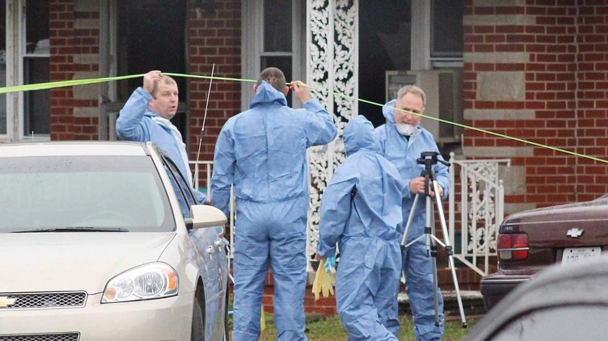 Investigators worked outside a home near MurrayWednesday where two adults and two children were found dead in the ashes of a suspicious fire the night before.