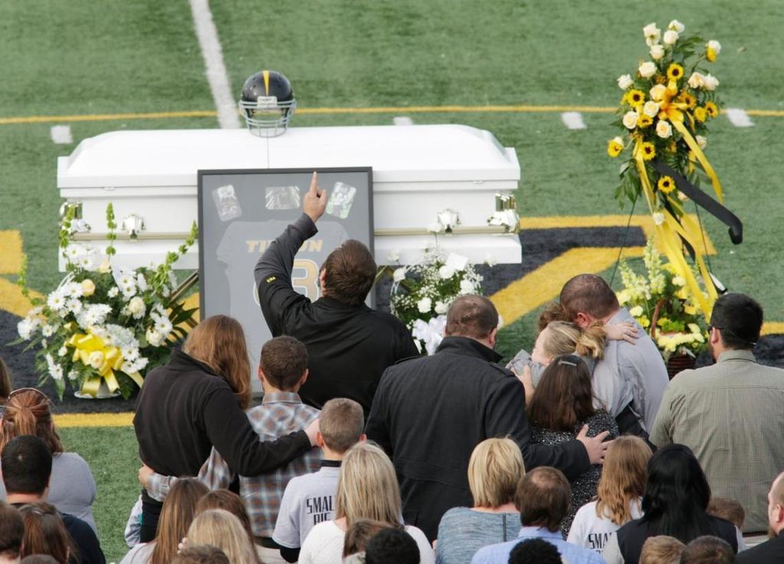 George Dean Tipton pointed to the sky during the funeral for his son Logan Tipton, age 6, at Falling Springs Recreation Center in Versailles on Dec. 11, 2015. Tipton, age 6, who was stabbed to death in his sleep by an intruder.