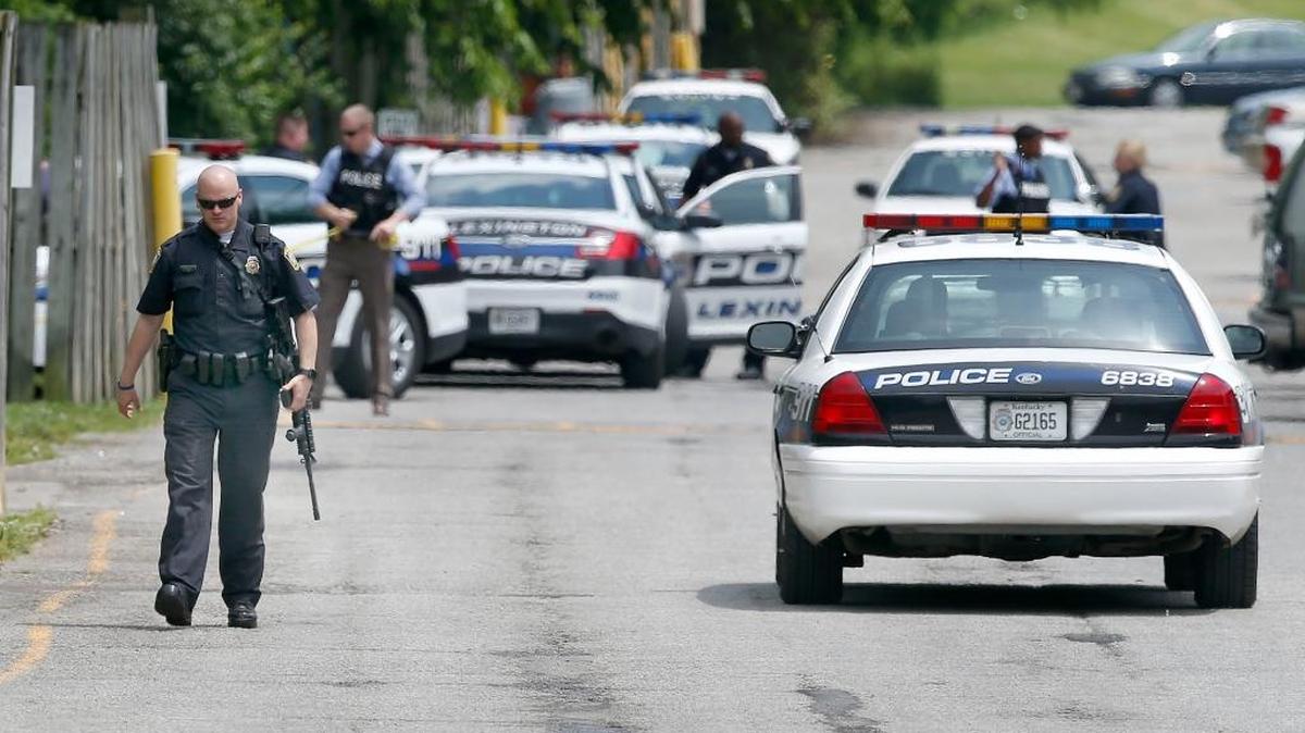Lexington police officers gathered behind an apartment complex on Cambridge Drive where arrests were made after Thursday’s robbery of a Central Bank on Versailles Road.