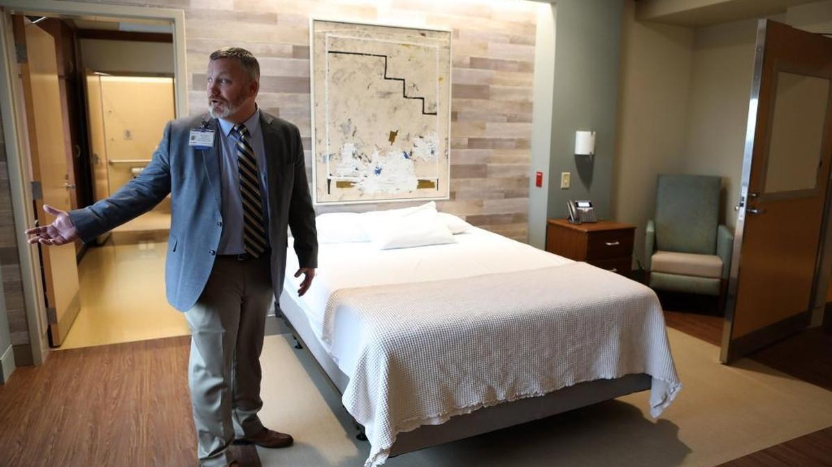 Mark Filburn, ambulatory director for Markey Cancer Center, discusses the new family suite, a hotel-style room that is connected to a patient room, during a tour of UK Markey Cancer Center's new inpatient units on the 11th floor of Pavilion A at the Albert B. Chandler Hospital in Lexington.