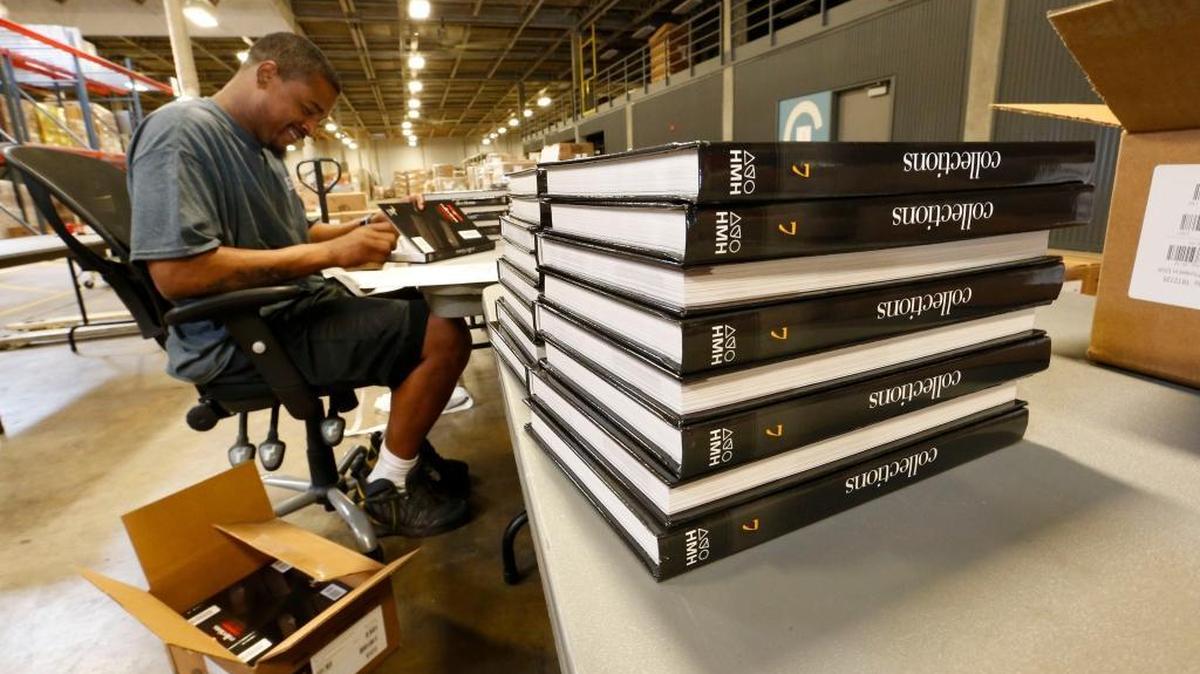 Warehouse employee Joshua Gaines put bar codes on new books at the Fayette County Schools warehouse, 1126 Russell Cave Road in Lexington.