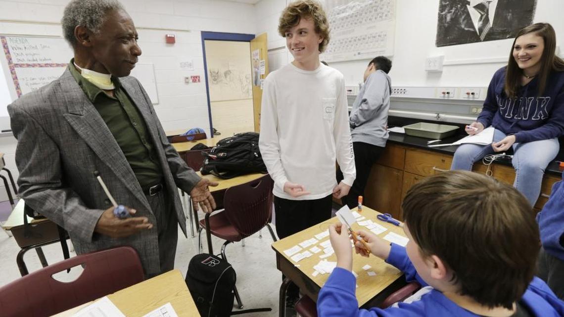 Substitute teacher Don Young, left, checked in on students, from left, Brock Littleton, Nick Hutson and Leia Blackstone at Lafayette High School Wednesday. Young was teaching a 10th-grade advanced biology class studying DNA by working on a mock murder investigation.