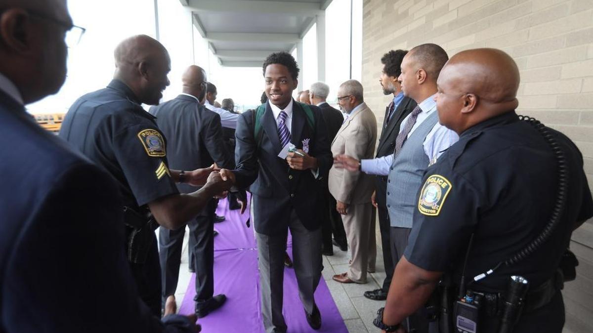 High school senior Tyriq Trigg, 17, was greeted by civic leaders as he arrived Wednesday for the first day of classes at Carter G. Woodson Academy in the new Frederick Douglass High School in 2017. Creating a similar program for younger students is under consideration by Fayette County public schools.
