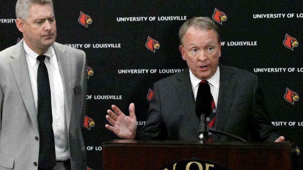 University of Louisville interim President Greg Postel, right, speaks as the university's Director of Media Relations John Karman listens during a press conference Wednesday, Sept. 27, 2017, in Louisville, Ky. Louisville announced Wednesday that they have placed basketball coach Rick Pitino and athletic director Tom Jurich on administrative leave amid a federal bribery investigation. Jurich is on paid leave, while Pitino is on unpaid leave.