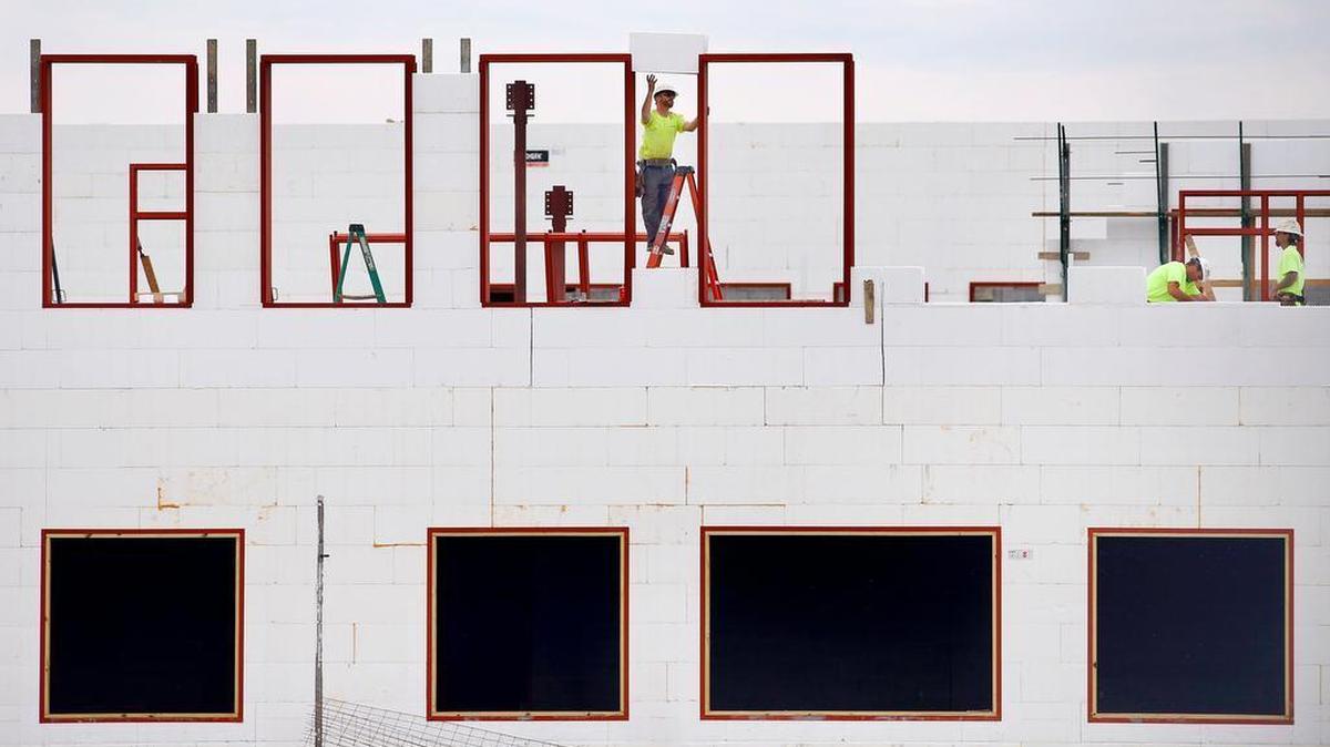 Workers installed new window frames as construction continues on a new Fayette County public high school, Thursday, March 10, 2016.