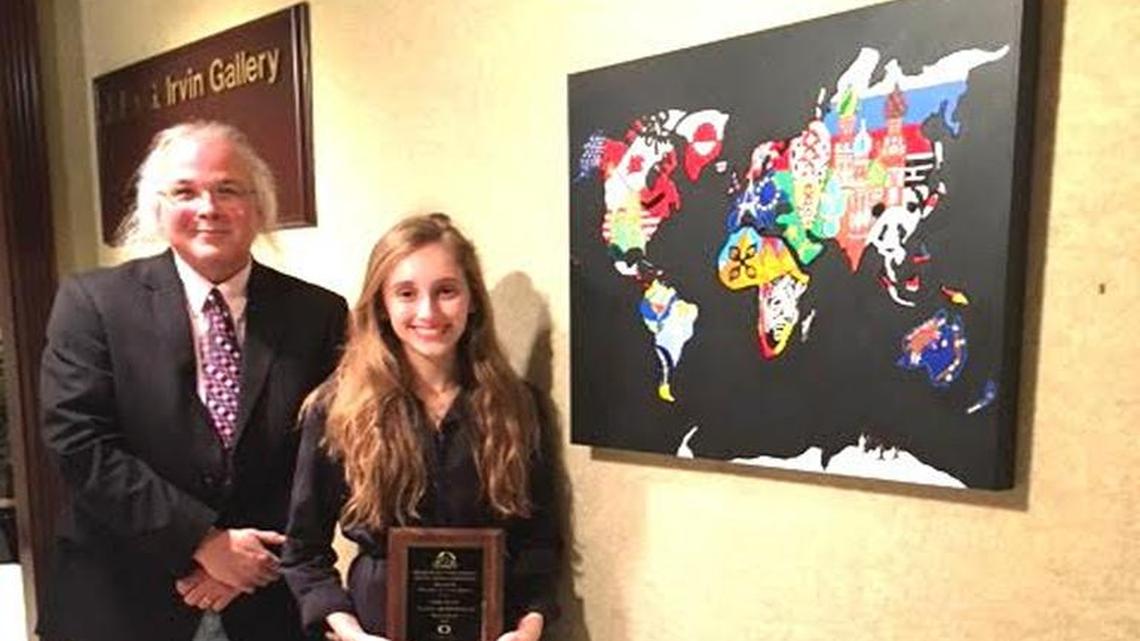 Bill Berryman, Sayre Upper School art teacher, with Sayre sophomore Alana Bloomfield, whose “Global Trotting” piece won the Lexington Sister Cities Young Artist Competition.