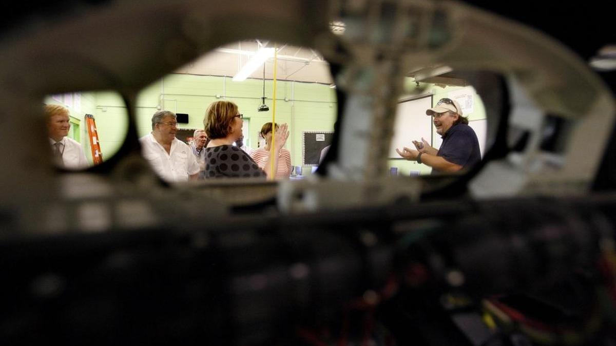 Killian Timoney, left, Dal Harper and Brandi Peacher looked on as Principal Daryn Morris, right, was seen through a dashboard talking about the needs in the electronics technology lab at Southside Technical Center in Lexington. Morris led the Fayette County Public Schools local planning committee on a tour of the school Wednesday.