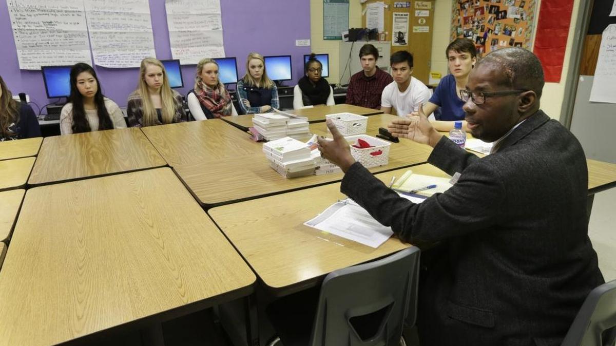 Superintendent Manny Caulk led a discussion with students at Paul Laurence Dunbar High School about a book the students have read.