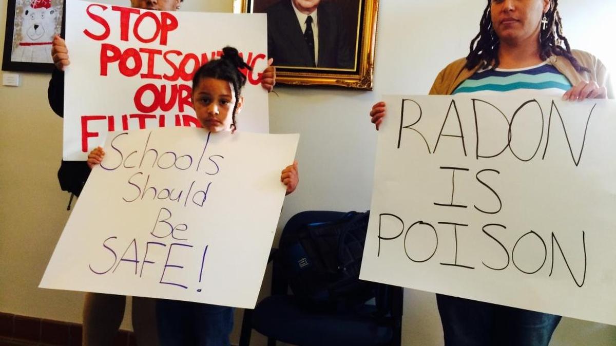 Gabrielle Williams, left, and Gianna Taylor-Martin, center, who attend Fayette County schools with high radon levels, joined their mother, Sarah Williams, outside Central Office on Monday to draw attention to the problem.
