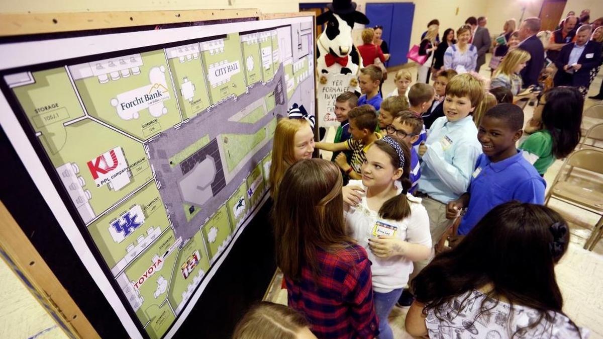 Veterans Park Elementary students looked at one of the renderings Thursday during a news conference where Junior Achievement of the Bluegrass unveiled its plan for the new JA BizTown/JA Finance Park in the gymnasium of the former Linee Elementary School in Lexington.