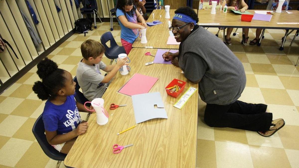 Teacher Vanessa Smotheras helped Zori Wyke-Sagne, 7, and Levi Hassloch, 7, during a class project at the YMCA camp held by Millcreek Elementary on Wednesday, June 20, 2016.