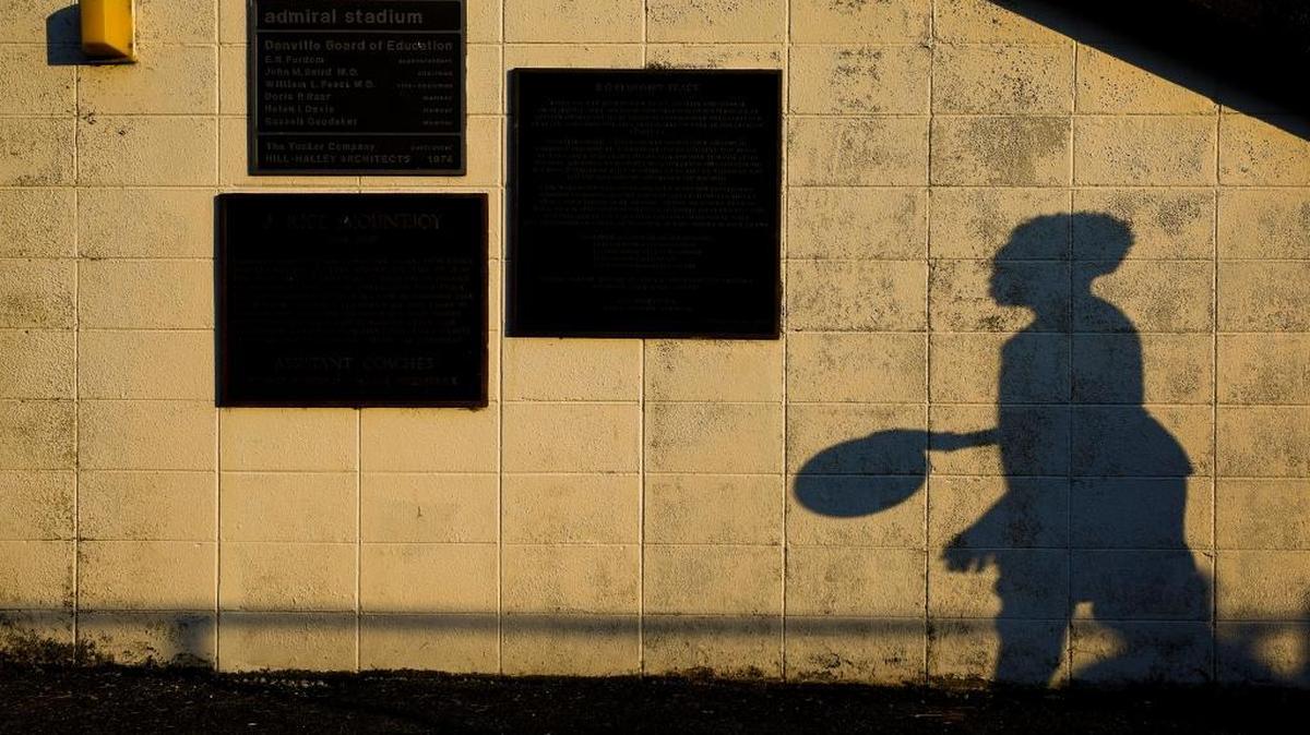 Jasper Johnson, 11, played basketball with friends before a football game between Danville and Frederick Douglass at Admiral Stadium in Danville.