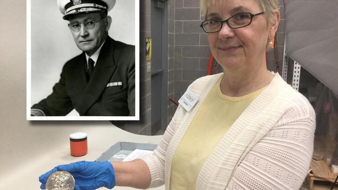 Sara Elliott, senior curator of the Kentucky Historical Society, holds a gold medal Kentuckian Willis A. Lee won in the 1920 Summer Olympics in Belgium.