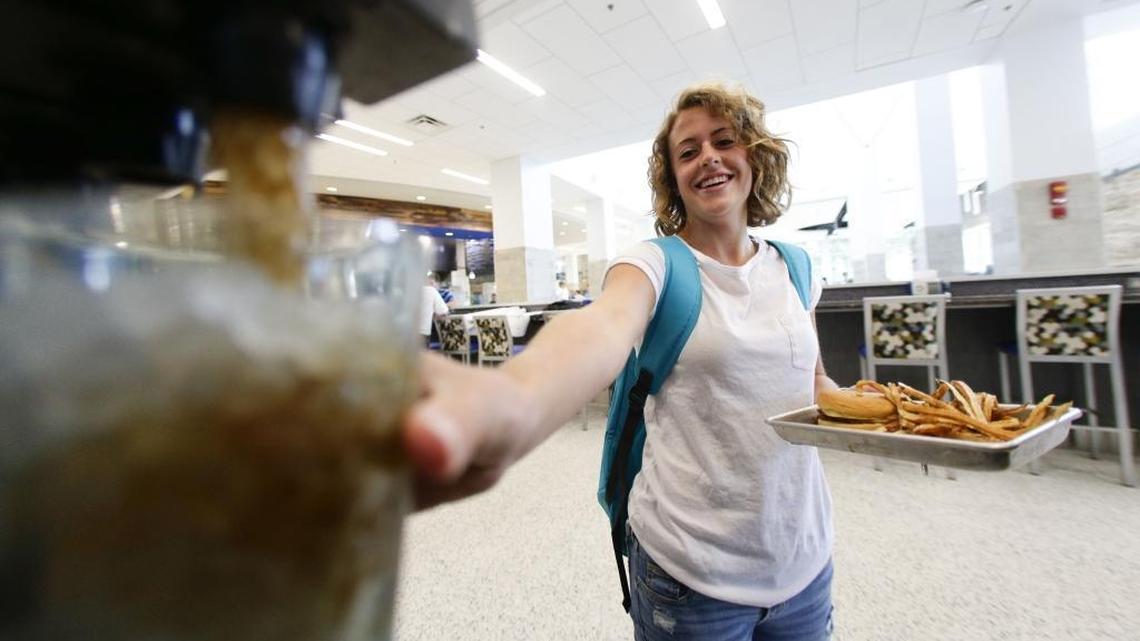 University of Kentucky student Sarah Harvey filled her glass with soda with her dinner at The 90 in August 2015. UK has announced that food-service vendor Aramark will no longer list soft drinks and ice sales among its local food purchases.