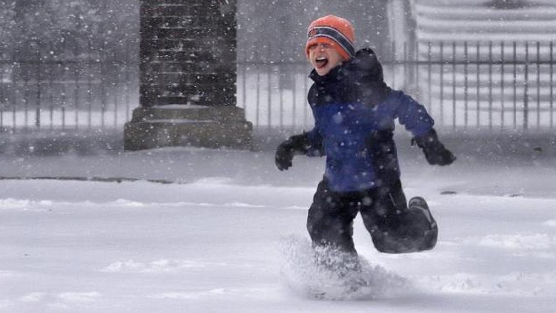 Sam Cramer, 7, dashes through the snow outside the New Jersey Transit Mountain Station in South Orange, N.J., on Thursday. With twisting winds and sideways gusts of snow, the first major snowstorm of the season lashed the New York area on Thursday, slowing commutes, shuttering schools and punishing those who stepped outside with weather that had charged from Florida up the East Coast.