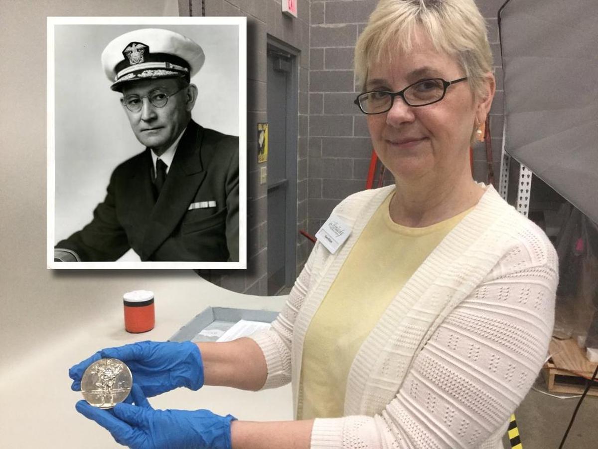 Sara Elliott, senior curator of the Kentucky Historical Society, holds a gold medal Kentuckian Willis A. Lee won in the 1920 Summer Olympics in Belgium.