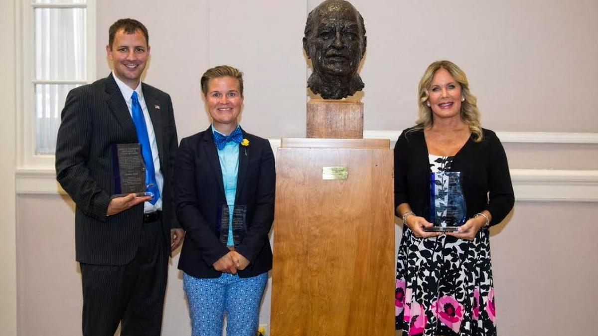 Earle C. Clements Innovation in Education Award winners, from left, Steven K. Riley, Whitney Walker and Amy Michele Madsen posed with a sculpture of Earle C. Clements at the University of Kentucky’s M.I. King Library Building.