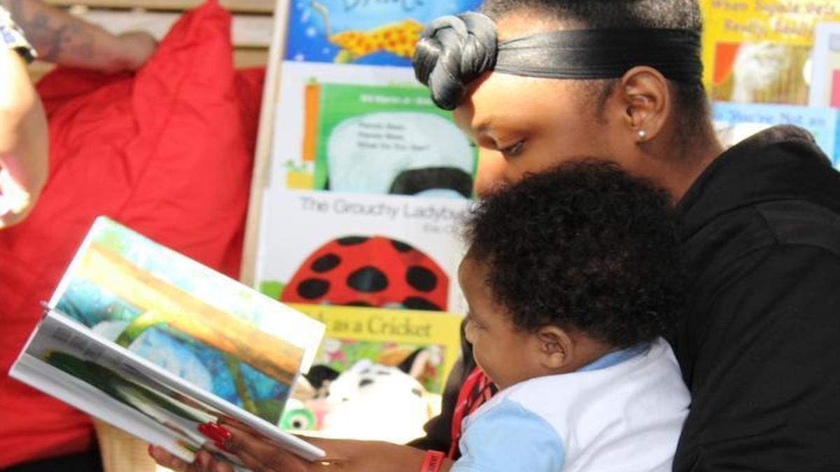 Kaylah Rodriguez, 17, read her 5-month old son, Shannon Alexander Washington III, the book “The Very Hungry Caterpillar” from a small library that’s a part of a new city-wide effort to give children from birth to age 5 more learning opportunities.