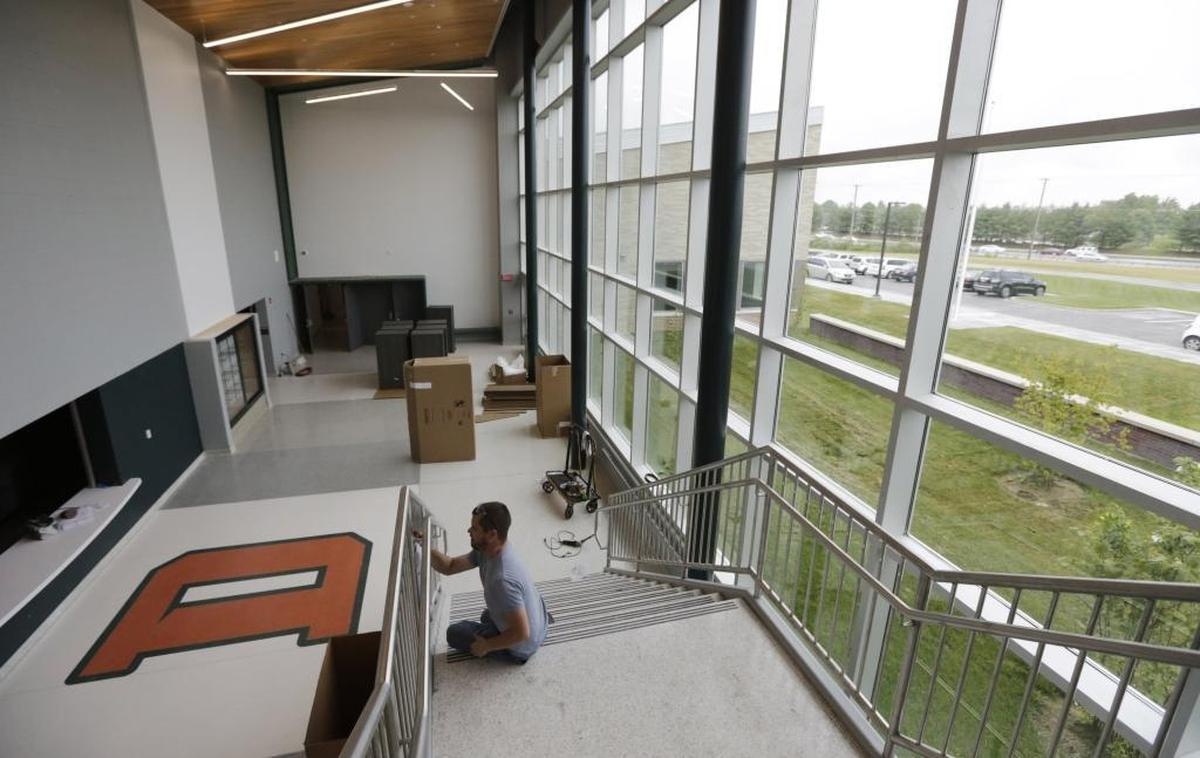 Bryon Fagin of Artistic Ironworks polished up the railing at Frederick Douglass High School .