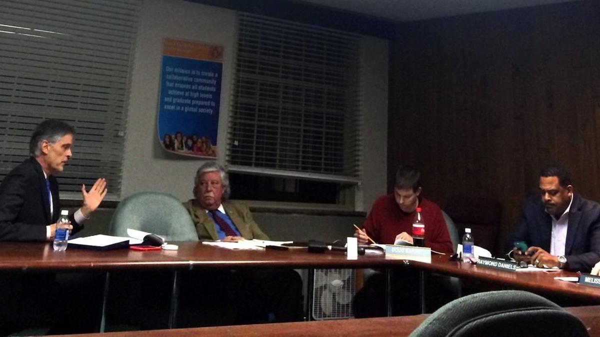 Lobbyists Bob Babbage, left, and Alan Stein on Thursday talked with Fayette County school board members, including Doug Barnett and Ray Daniels, right.