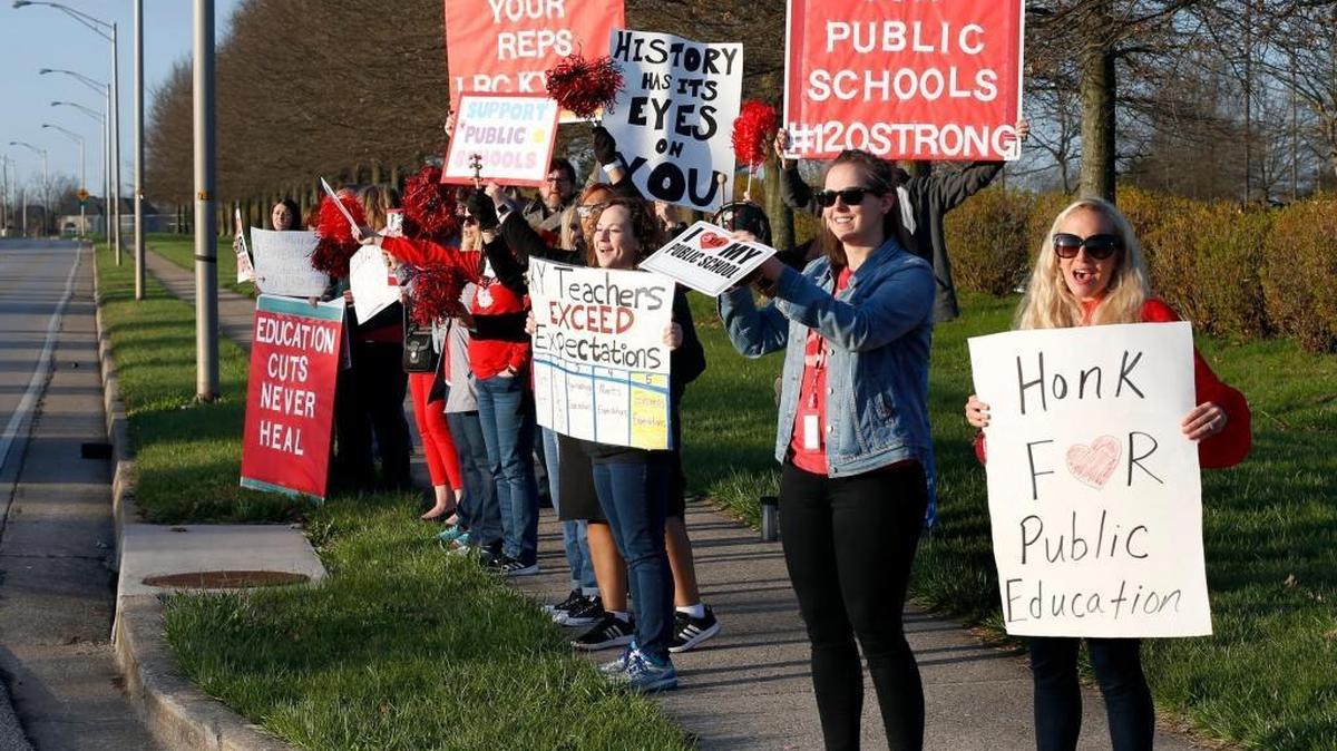 Some Paul Laurence Dunbar High School teachers and staff members held signs Thursday morning in front of the school on Man o’ War Boulevard to protest education spending. Fayette County classes have been canceled for Friday so teachers and staff can go to Frankfort in a show of strength for lawmakers.