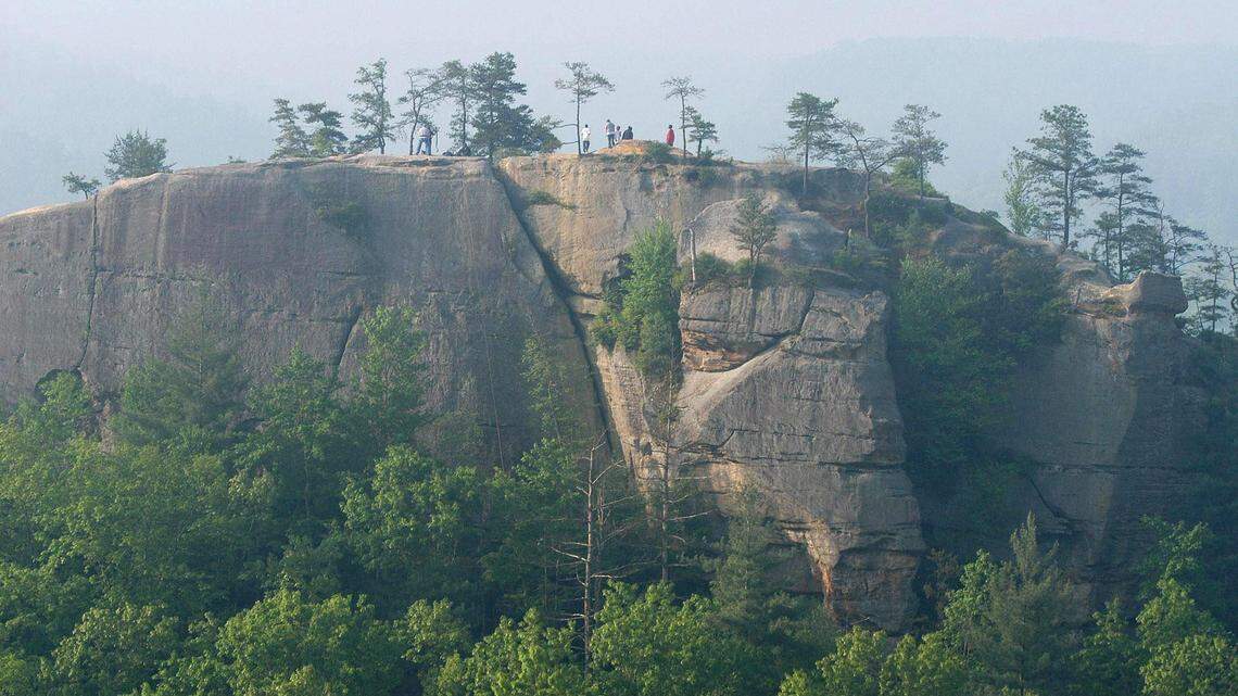 People climb around the top of Half Moon Rock in the Red River Gorge in Wolfe County in this 2004 file photo.