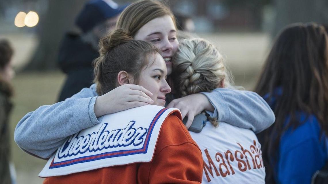 In this file photo, Alyssa Edging, center, a student at McCracken County High School, embraces Erica Johnson, left, and Abigail Hicks, both juniors at Marshall County High School in Benton, Ky., following a prayer vigil at Paducah Tilghman High School in Paducah on Jan. 24, 2018.