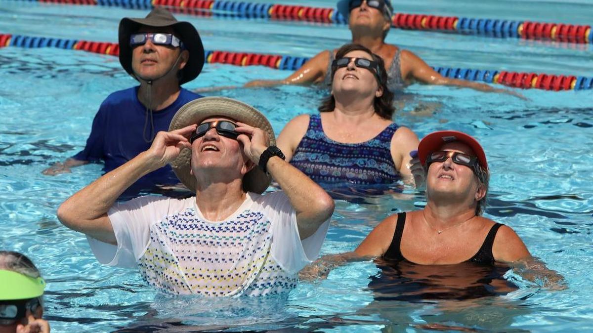 Participants in the senior aquatic class at Tates Creek Aquatic Center in Lexington took a break to watch the eclipse on Aug. 21. The eclipse reached nearly 95 percent totality in Lexington.