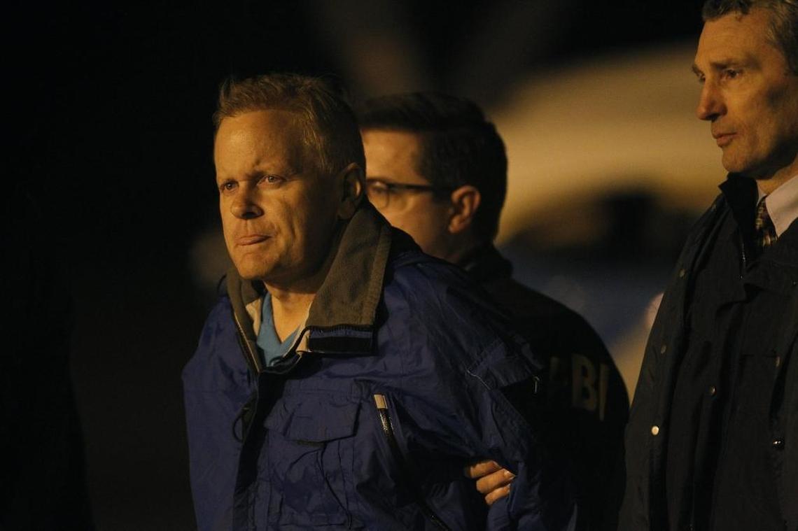Fugitive lawyer Eric Conn is taken in to custody by FBI agents on the tarmac at Blue Grass Airport in Lexington, Ky., Tuesday, December 5, 2017.
