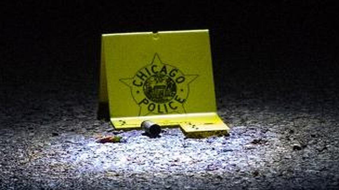 An evidence marker sits next to a shell casing at the scene of a recent Chicago shooting.