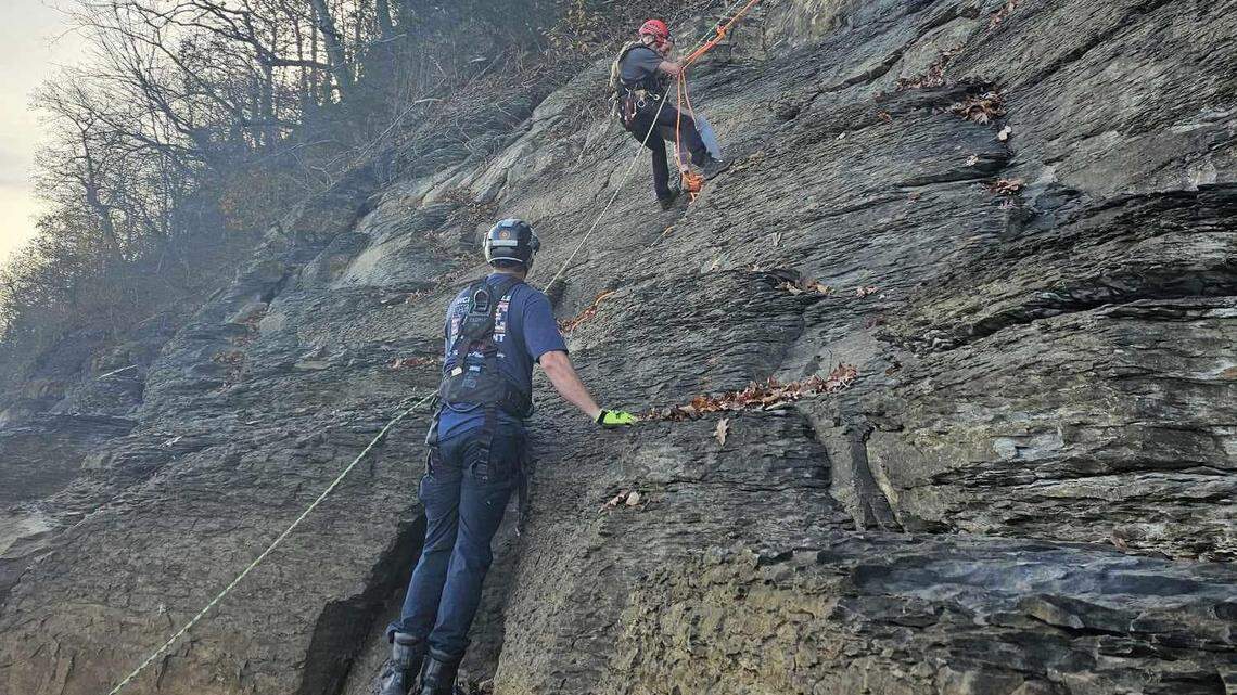 Two people who fell up to 250 feet from a cliff were rescued after their “cries for help” were heard, officials say.
