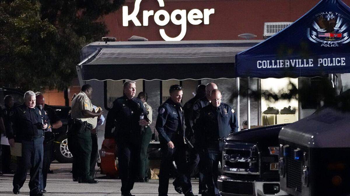 In this Thursday, Sept. 23, 2021, file photo, law enforcement personnel work in front of a Kroger grocery store as an investigation goes into the night following a shooting earlier in the day in Collierville, Tenn. An employee of the Kroger supermarket chain who was wounded has sued the company, claiming it failed to protect employees from the fired contractor who killed one person and hurt 14 others.