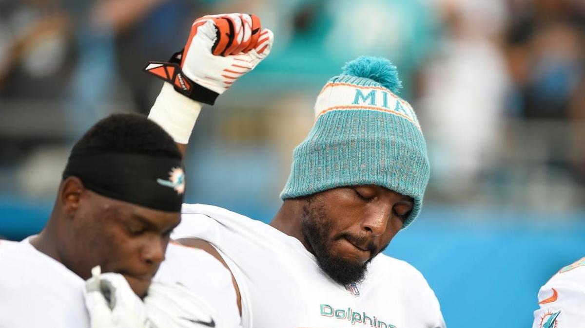 Miami Dolphins’ Robert Quinn raised his fist during the national anthem before a preseason NFL football game against the Carolina Panthers in Charlotte, N.C., on Friday.