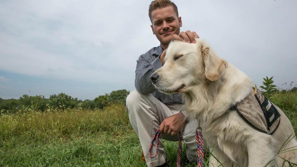 Matt Moores, a retired Marine sergeant, with his service dog, James, at the Warrior Canine Connection in last month.