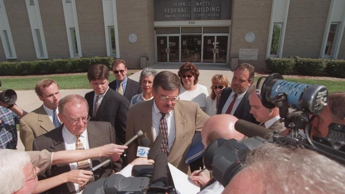 Kent Downey is sentenced Aug. 19, l998 at the John C. Watts Federal Building in Frankfort on charges of promoting prostitution and gambling. Downey, center, talks with the media outside the Federal Building after sentencing.