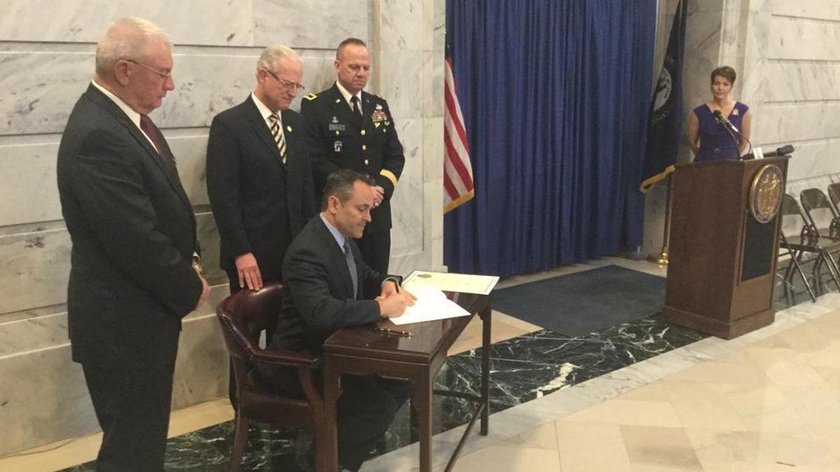 Gov. Matt Bevin signs into law a bill to honor Vietnam veterans every March 30. Looking on, from left, are incoming Department of Veterans Affairs Commissioner Norman Arflack, state Sen. Ernie Harris, Adjutant General Stephen Hogan and deputy Veterans Affairs Commissioner Heather French Henry.