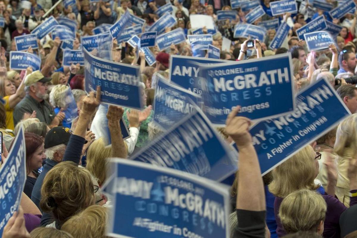 Amy McGrath supporters wave their signs during a rally for the Democratic Kentucky Sixth Congressonal District candidate Friday October 12, 2018, in Owingsville, Ky.