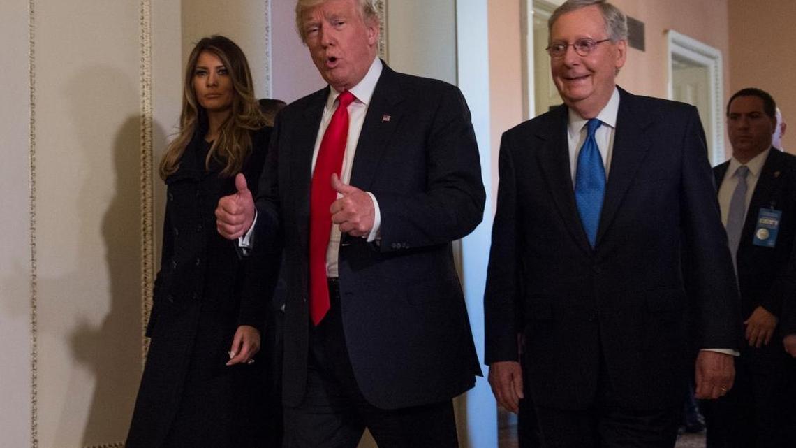 President-elect Donald Trump, flanked by his wife Melania and Senate Majority Leader Mitch McConnell of Ky., gives a thumbs-up while walking on Capitol Hill in Washington, Thursday, Nov. 10, 2016, after their meeting.