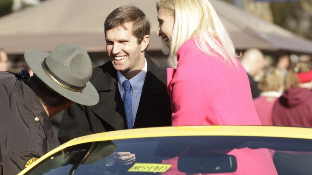Attorney General Andy Beshear and wife Britainy Beshear arrived at the viewing stand during the Governor's Inauguration Parade on Capital Avenue in Frankfort, Ky, on Dec. 8, 2015.