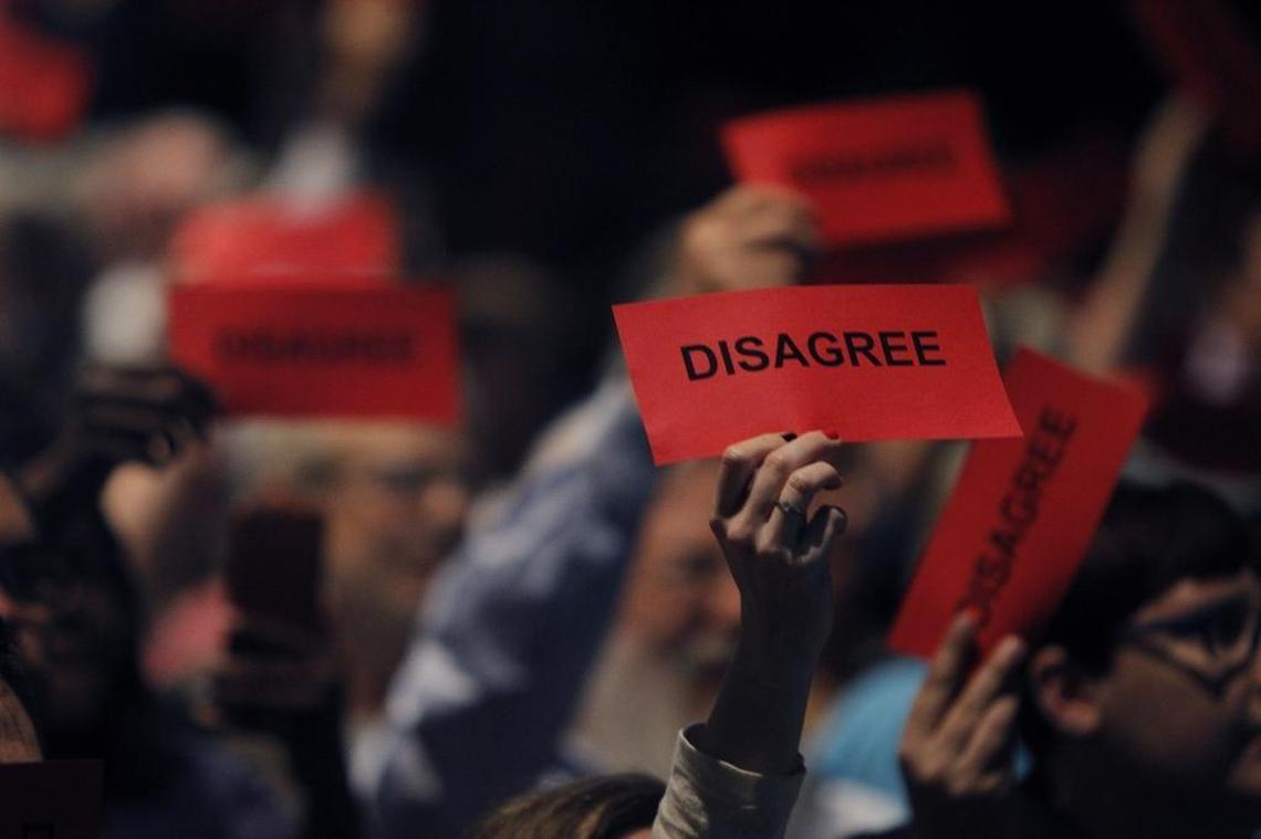 Folks held up disagree signs as U.S. Rep. Andy Barr spoke during his town hall in the Beeler Auditorium at Lafayette High School in Lexington, Ky., Monday evening, April 24, 2017.