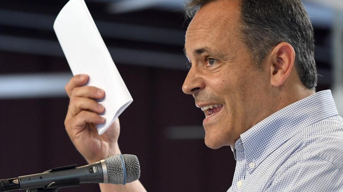 Kentucky Gov. Matt Bevin holds up what he called a summons from Attorney General Adam Beshear during his speech Saturday August 6, 2016, at the Fancy Farm Picnic at Fancy Farm, Ky.