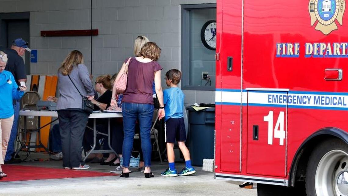 Voters signed in to vote at the Fairhaven voting precinct located in the truck bay at Lexington Fire Department Fire Station 22 on Clearwater Drive.
