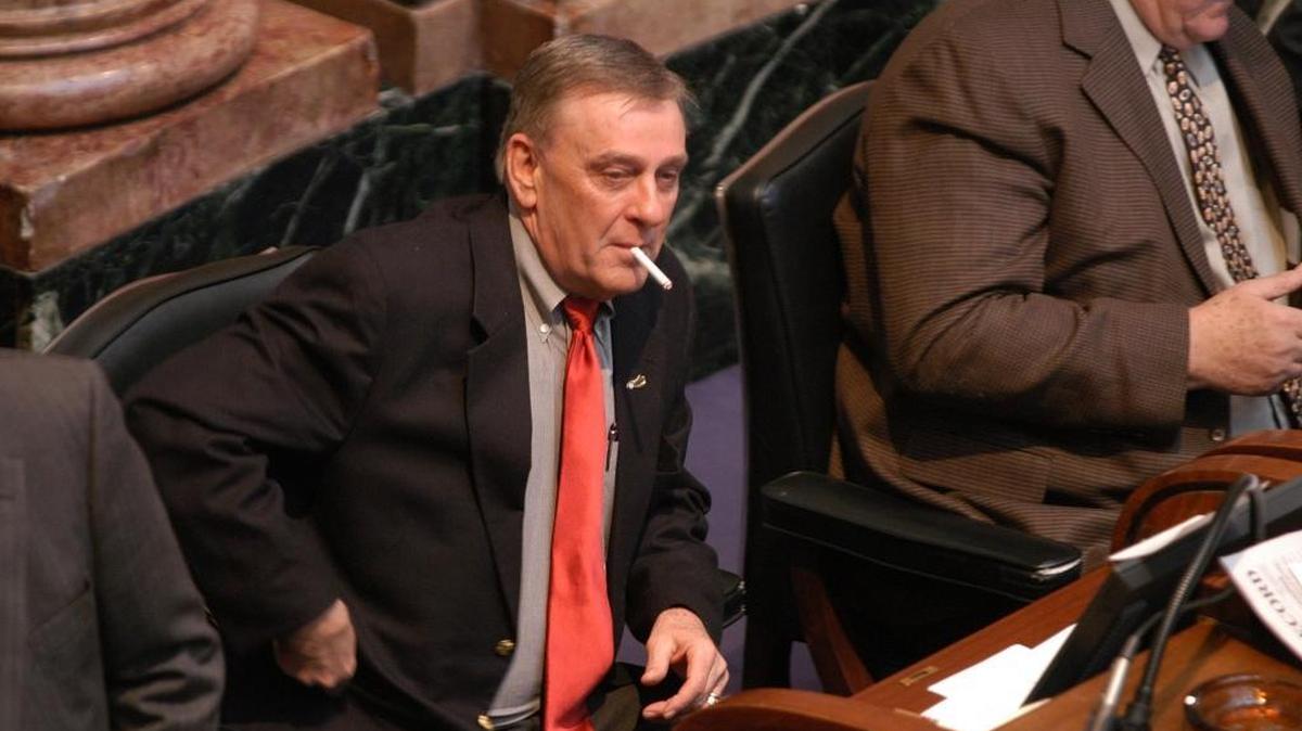 State Representative John Arnold Jr. smokes a cigarette at his desk in the House chambers in the State Capitol in Frankfort, KY., Wednesday, January 21, 2004.