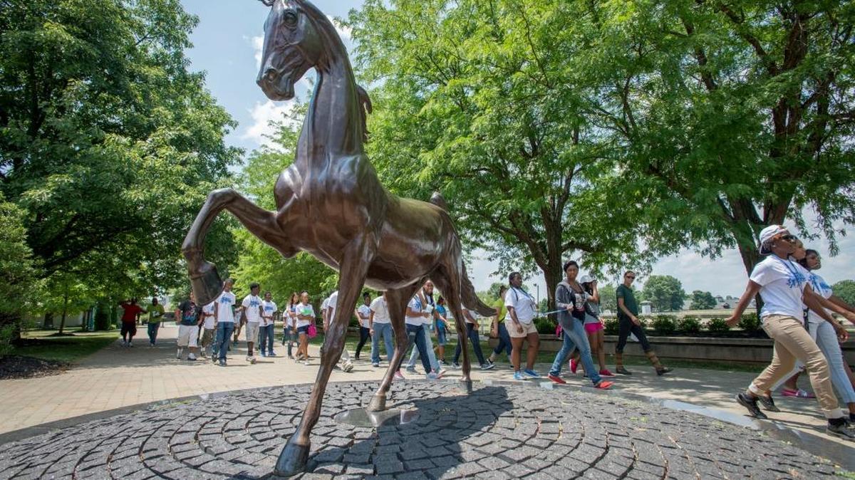 Students walk past a horse statue at The Kentucky Horse Park. Participants in the Summer Youth Employment Program in Lexington took a tour of the Kentucky Horse Park thanks to a public-private partnership with Partners for Youth and Equestrian Events, Inc. Equine Career Days for the students were organized on July 10 at the Kentucky Horse Park.