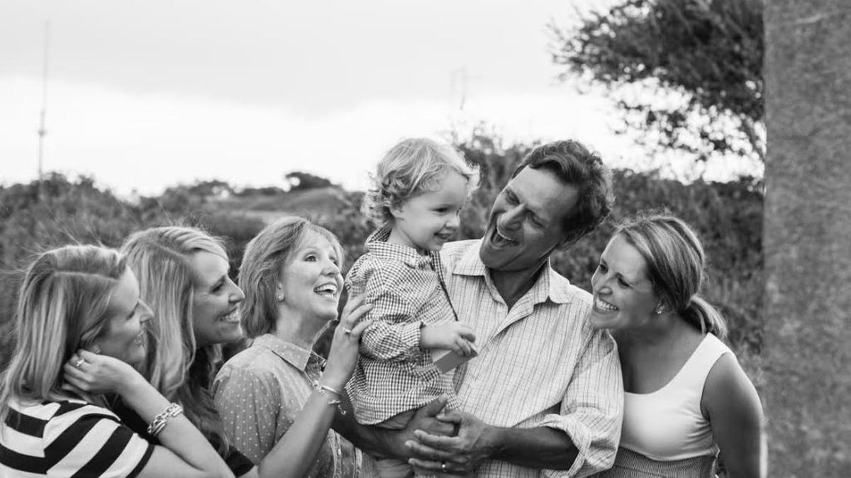 Mark Hinkel, second from right, holding his grandson, Henry Lewis, with daughters Andrea and Kaci Hinkel, wife, Mary-Lynn Hinkel, and daughter Lauren Lewis. Hinkel was killed last year by an alleged drunken driver during a cycling event in Scott County.