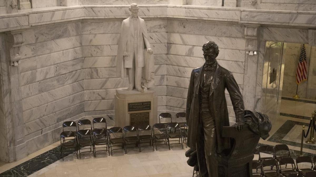 The Jefferson Davis statue (left) sits amid other statues, including Abraham Lincoln, in the Capitol Rotunda at the Kentucky State Capitol in Frankfort, Ky., on Thursday, January 11, 2018.